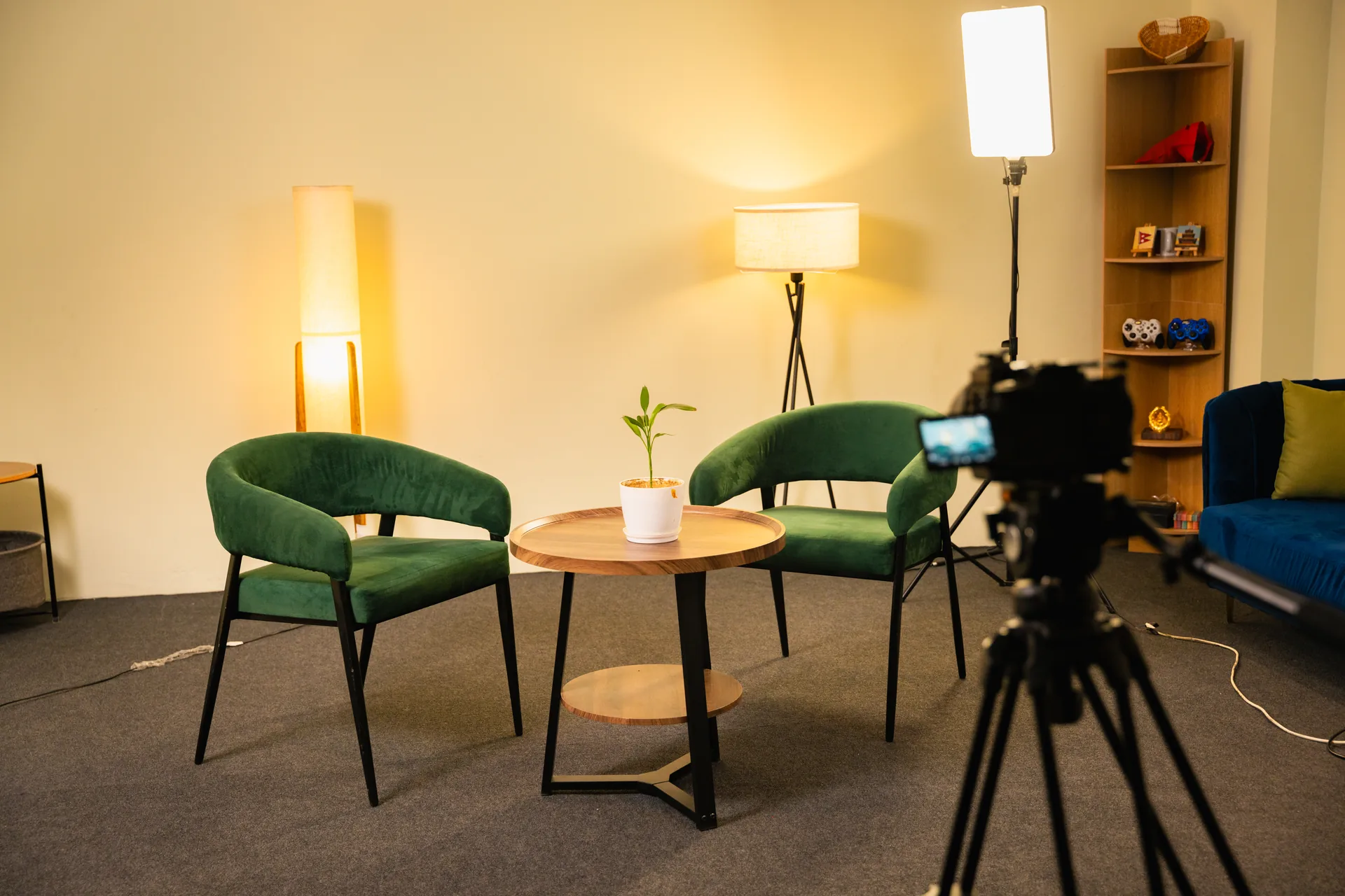 Warm interview set framed through a studio camera